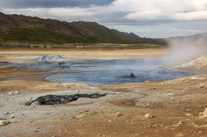 Steaming geothermal area with bubbling mud pools at Namaskard Myvatn Iceland