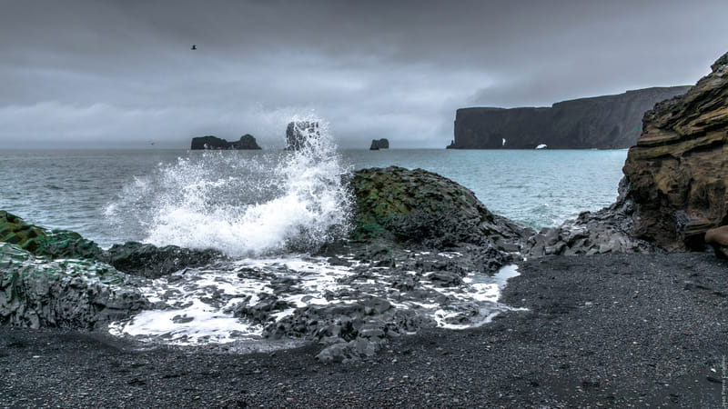 Brimketill lava rock pool with crashing waves