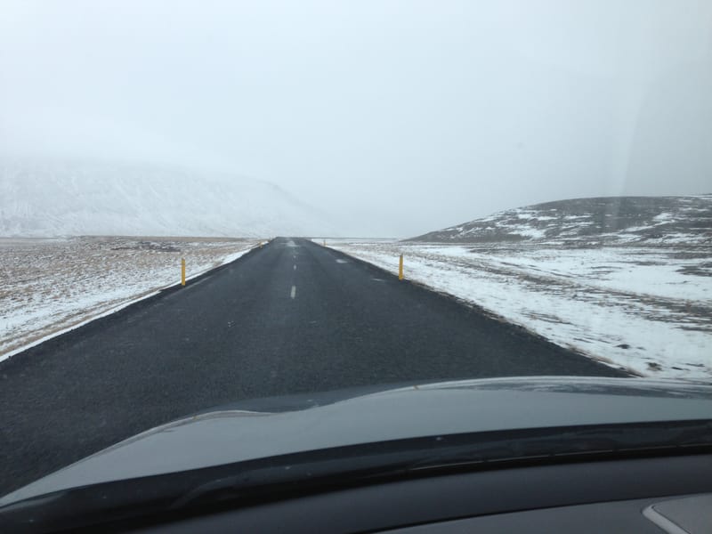 Car driving through dramatic Iceland landscape on Ring Road