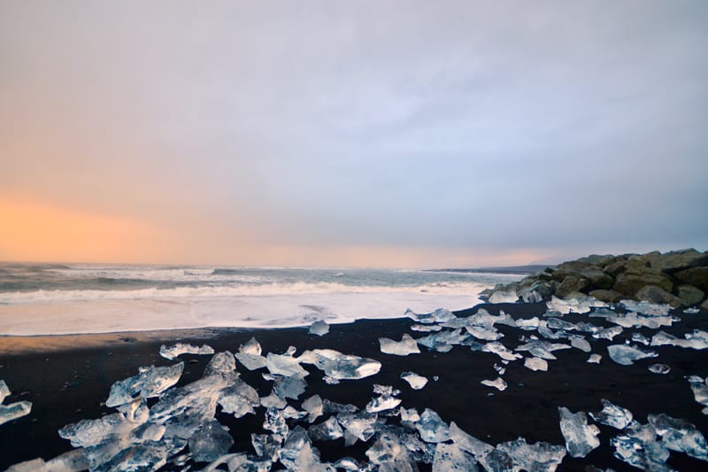 Ice chunks on Diamond Beach with sunrise light