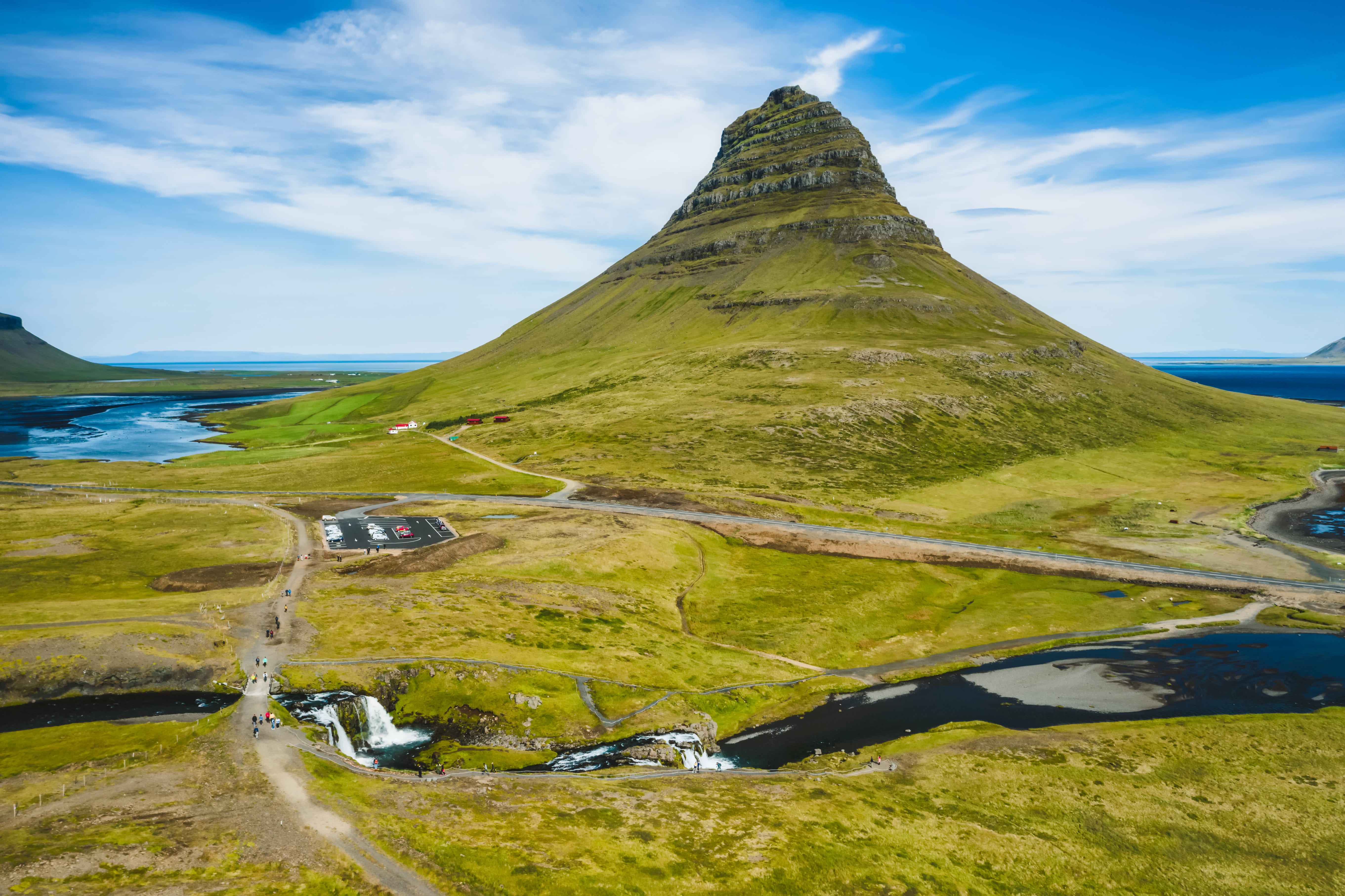 aerial view of kirkjufell mountain landscape and waterfalls below in iceland