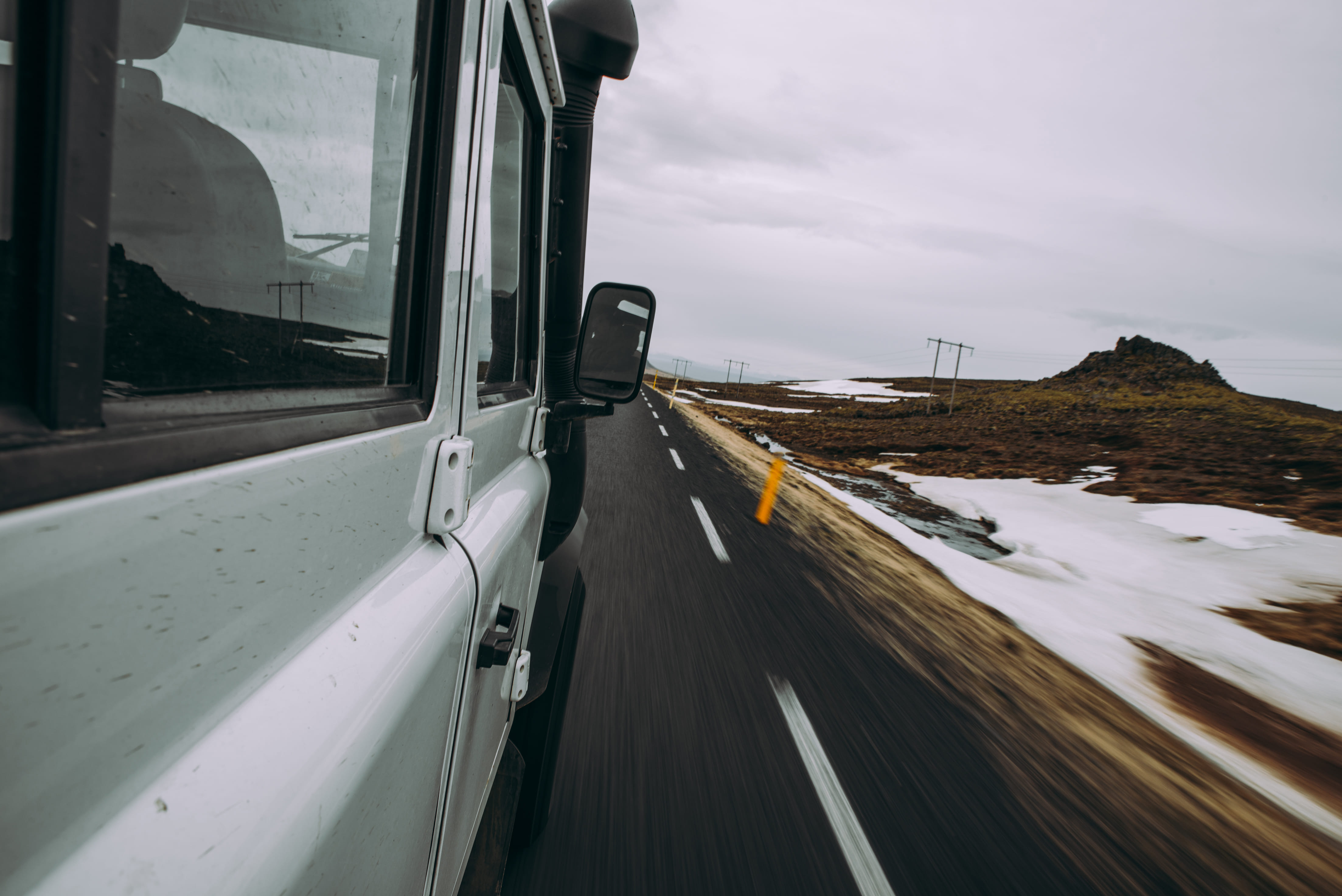 Car moving road against sky seen through glass window