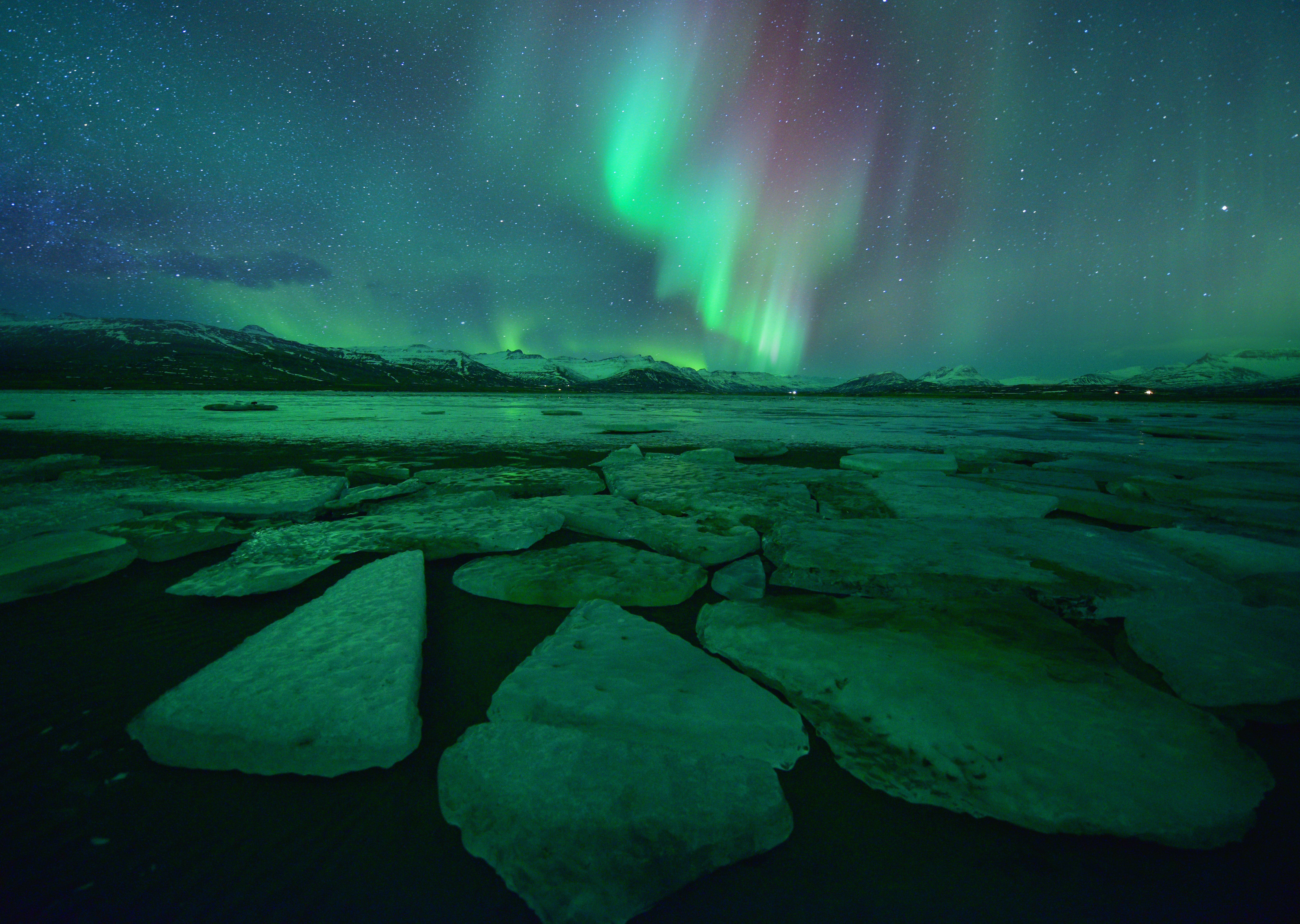 Spectacular auroral display over the glacier lagoon Jokulsarlon in Iceland