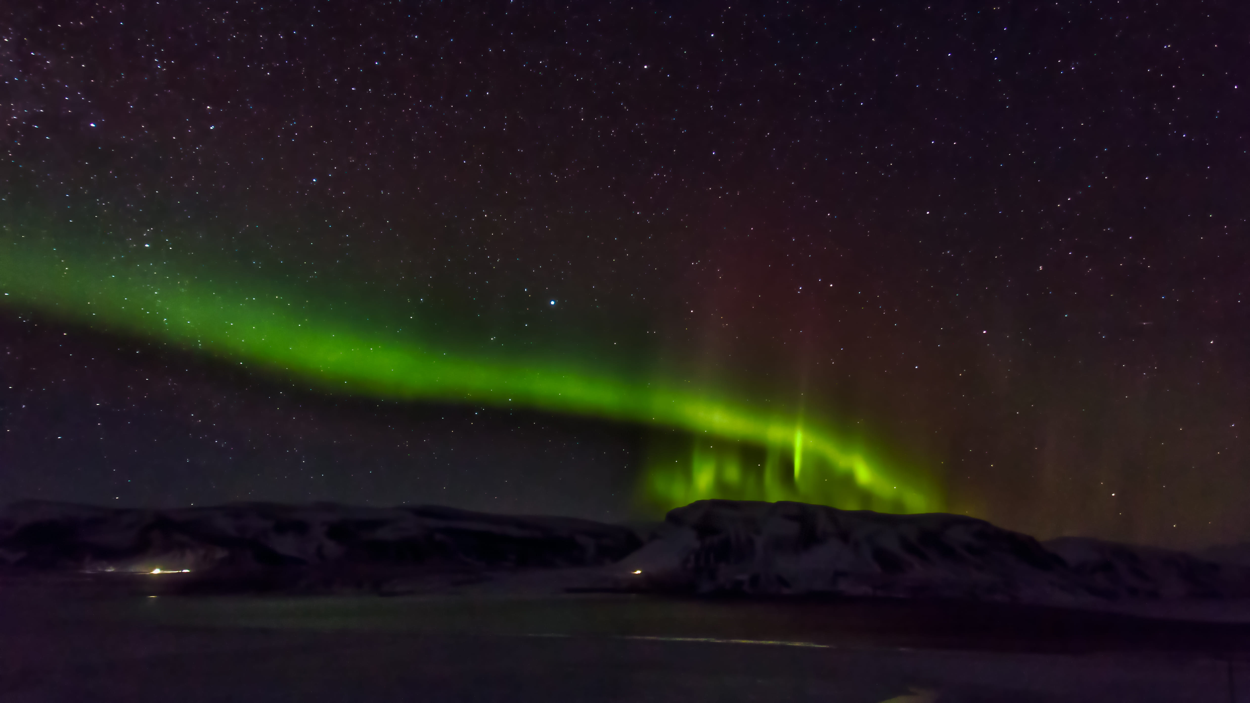 Scenic view of aurora borealis over mountains in iceland at night