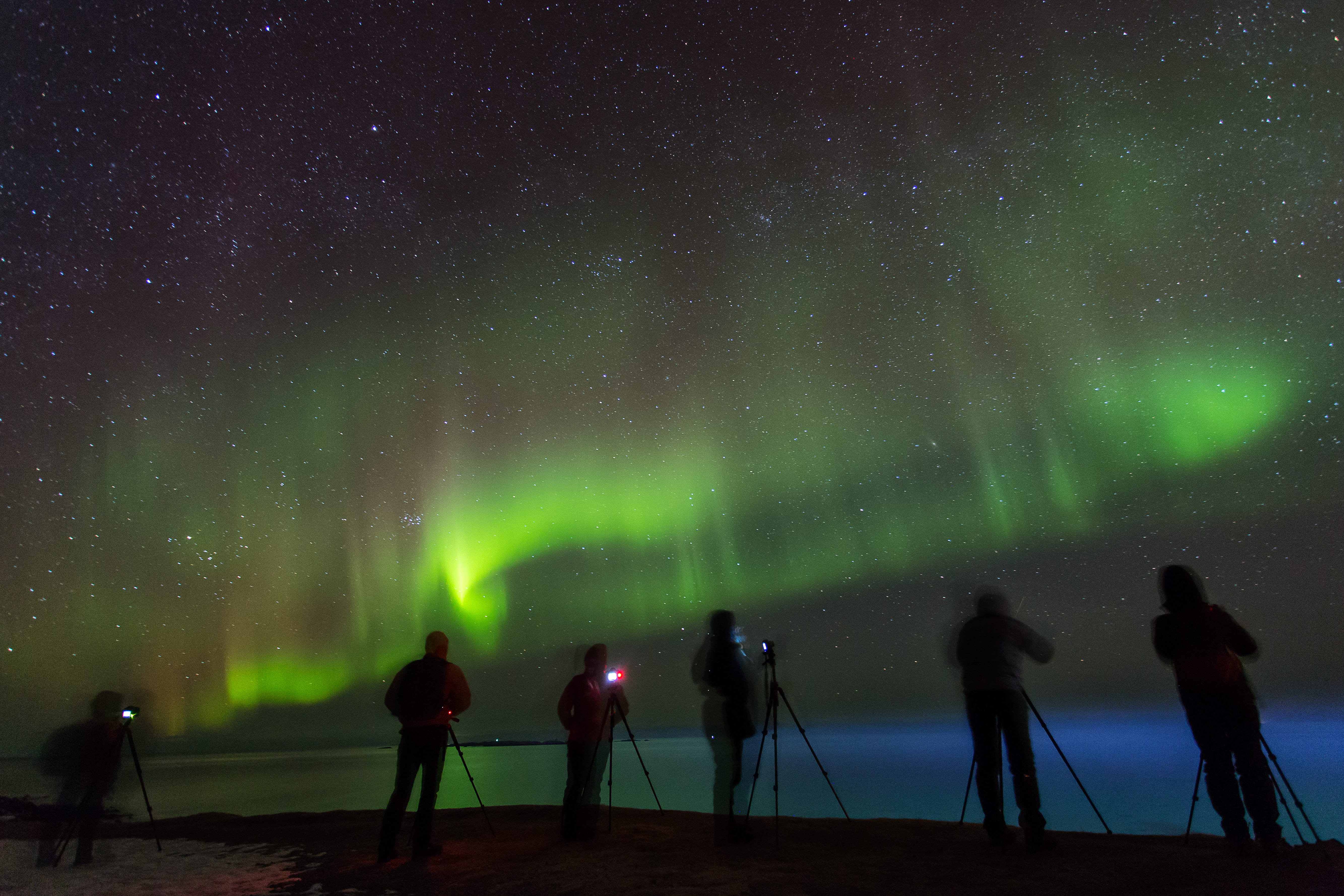 People photographing aurora borealis at night