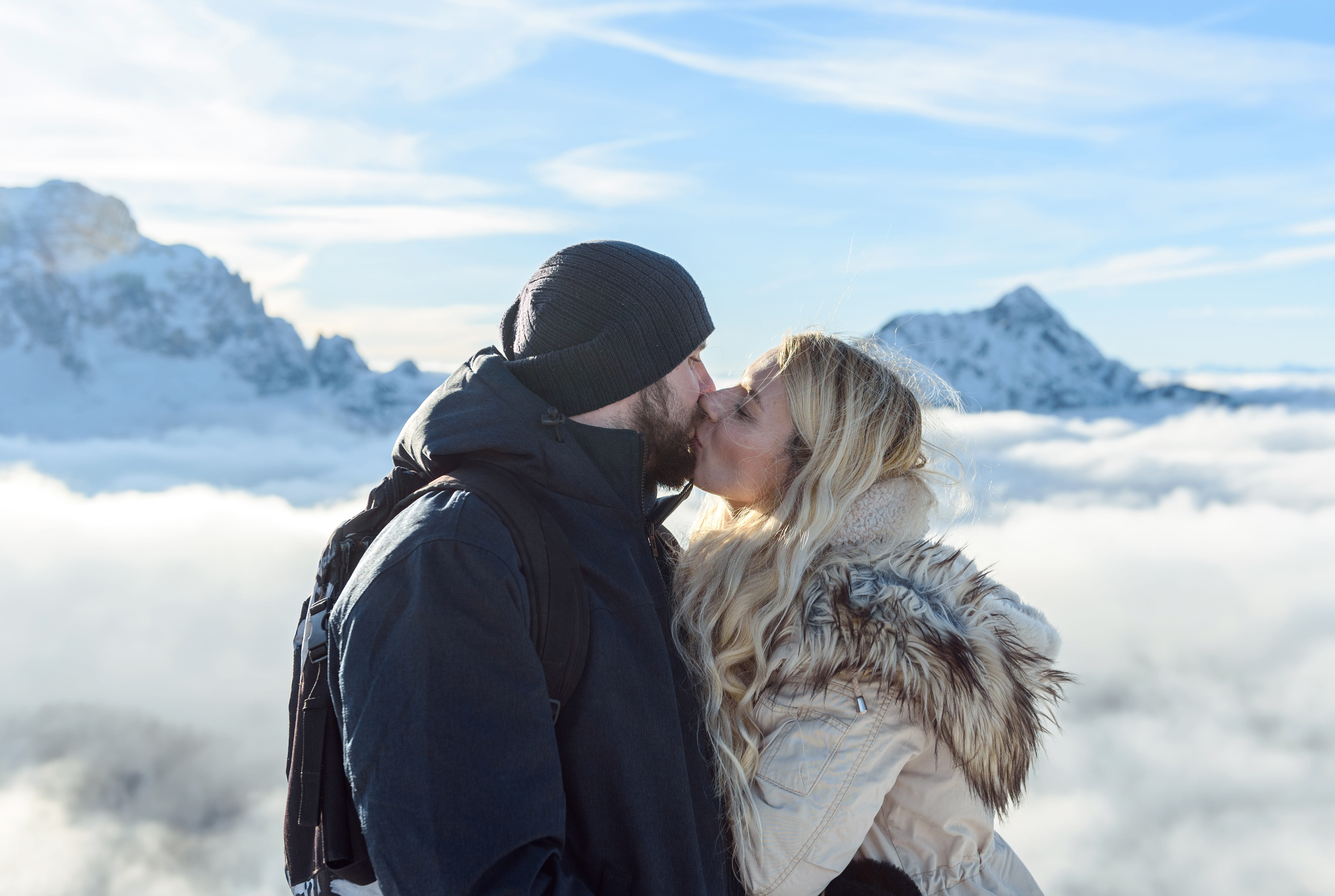 Couple in snowy Iceland landscape with aurora borealis